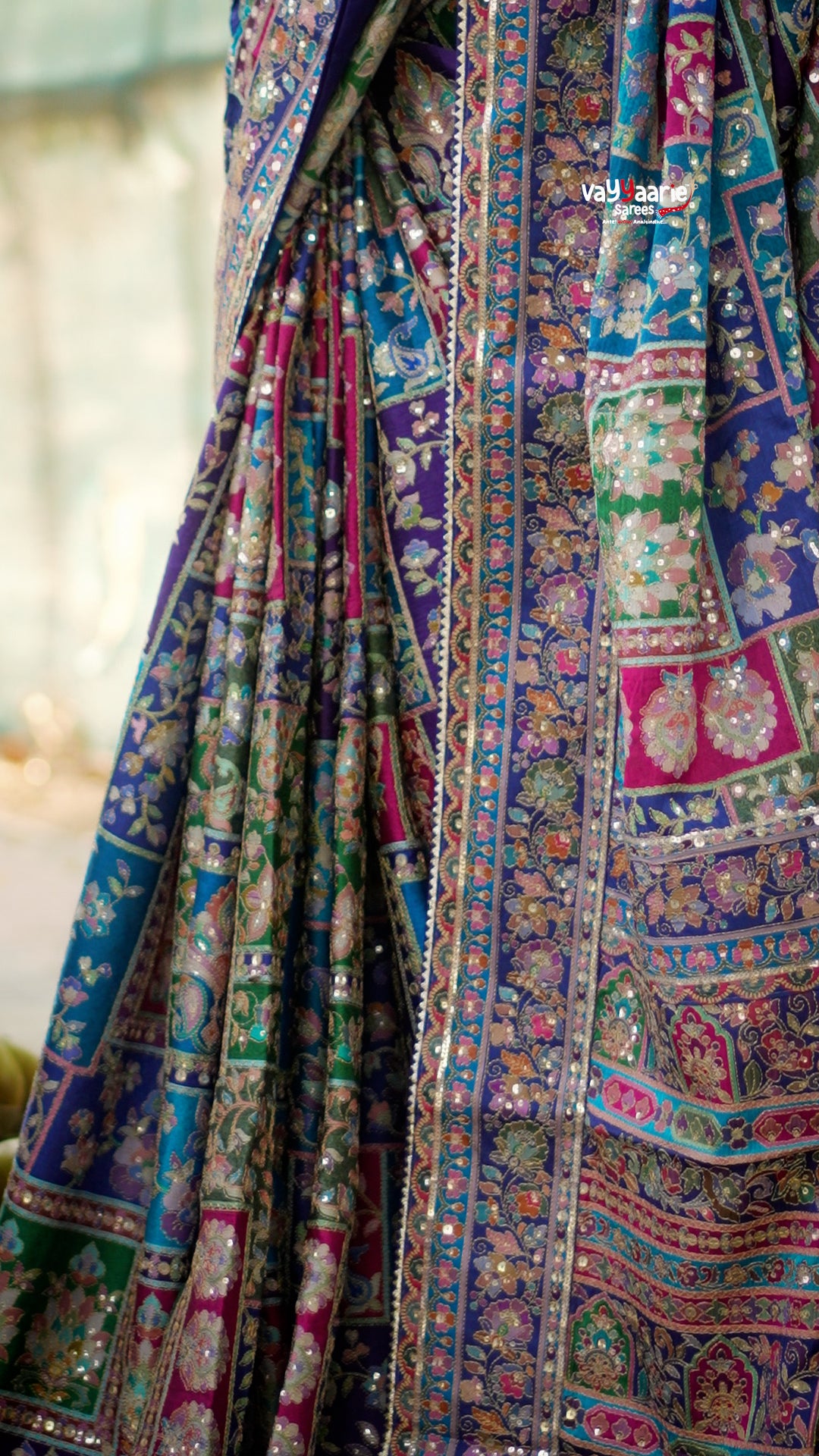 Elegant designer saree blooming with vibrant paisley charm and timeless festive vibes.
