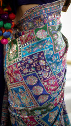 Elegant designer saree blooming with vibrant paisley charm and timeless festive vibes.